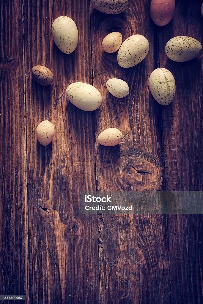 Colorful Easter Eggs Decorated on Wooden Background Colorful Easter eggs on wooden background. They can be painted in various colors and can be given on Easter or springtime. Decorating Easter Eggs is fun and creative activity which you can do with your family. Colored Easter Egg is a universal symbol of Easter. 2015 Stock Photo