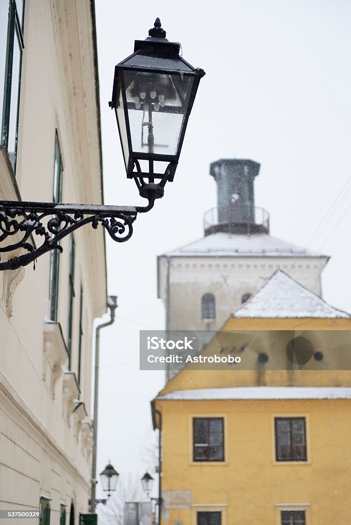 Gas lantern in Zagreb, Croatia Closeup of a gas lantern in Zagreb, Croatia, with a view of Lotrscak Tower in the background, during a snowstorm. 2015 Stock Photo