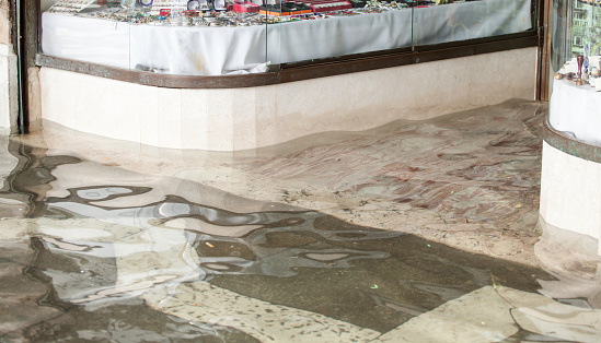 Detail of the entrance of a store during high water in Venice, Italy.
