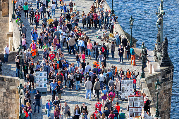 crowd of tourists on Charles Bridge over Vltava River in Prague, Czech Republic, elevated view