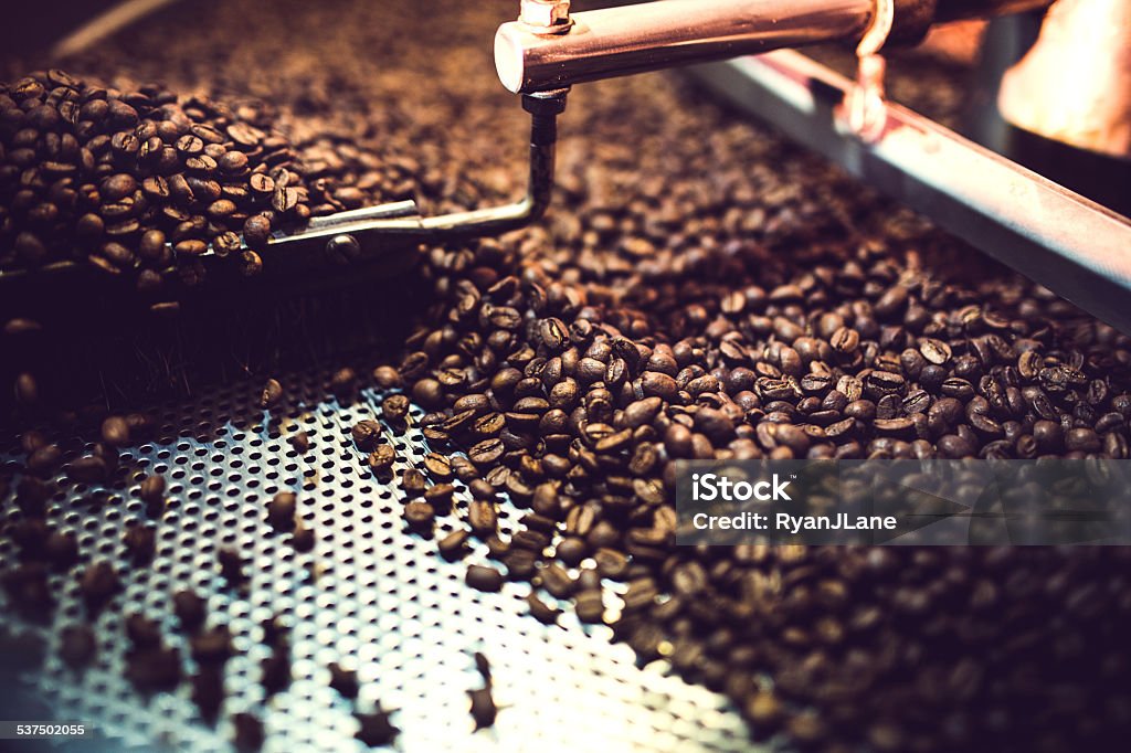 Coffee Roaster Cooling Batch of Beans The process of roasting a batch of high quality single origin coffee beans in a large industrial roaster; the toasted beans are in the cooling cycle.  Horizontal image with copy space. Coffee Roaster Stock Photo
