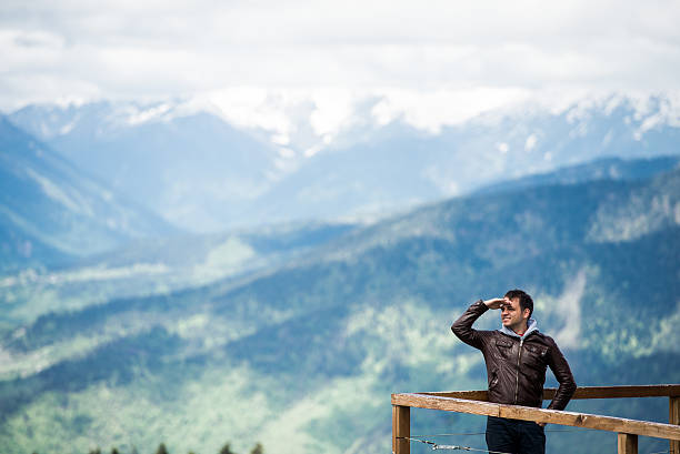 istock Young man in the mountains looking with hand over his 537508810
