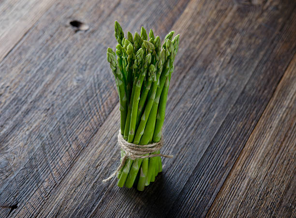 istock Fresh Green Asparagus on wooden table. 537509238