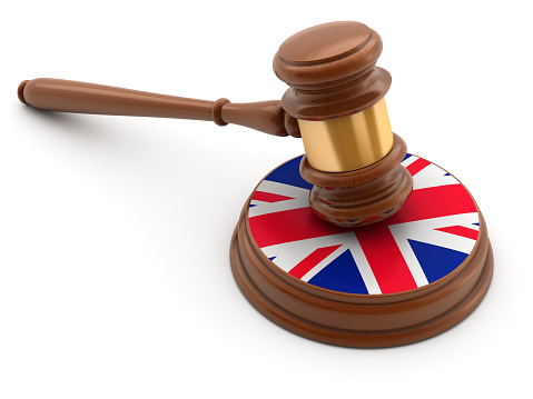3D image of isolated gavel with flag of United Kingdom.