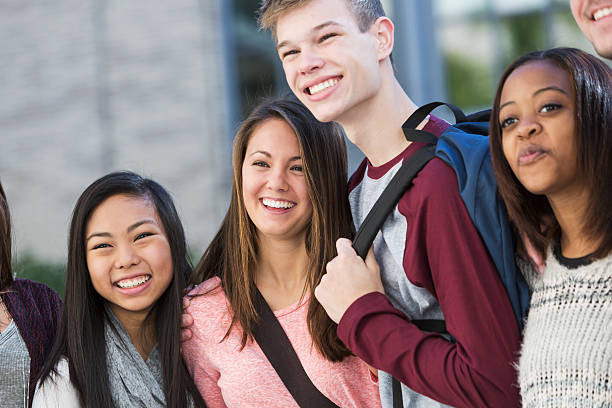 istock Group of students standing in a row outdoors 537513427