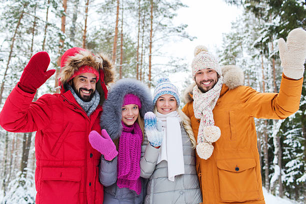 istock group of friends waving hands in winter forest 537513509