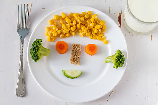 Vegetables on a plate arranged to look appealing to kids, milk
