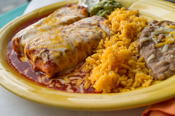 Mexican Chimichanga Burrito Authentic Mexican chimichanga burrito with sour cream jalapeno and cilantro mexican food photos stock pictures, royalty-free photos & images