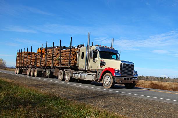 istock Semi-truck on a highway with a load of logs 537515527