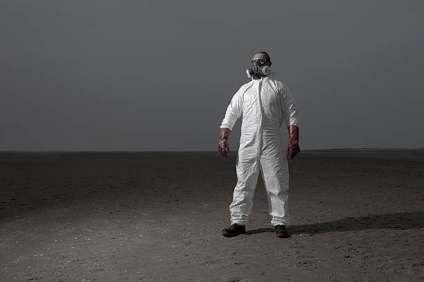 istock Man wearing hazard protection suit in dark landscape 537515565