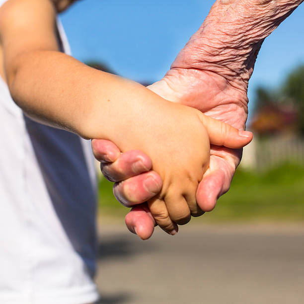 istock Close-up hands, grandmother holding a child hand 537515939