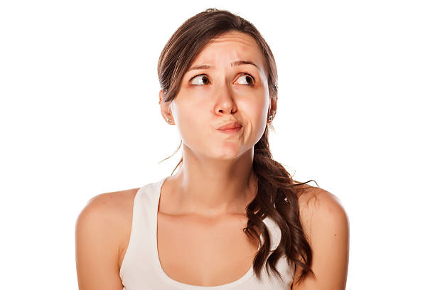 istock Confused young woman posing on a white background 537516519