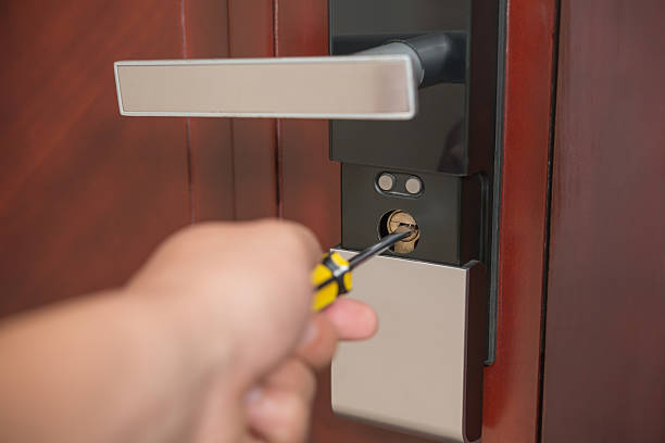 istock trying to open a door lock by screw driver 537516546