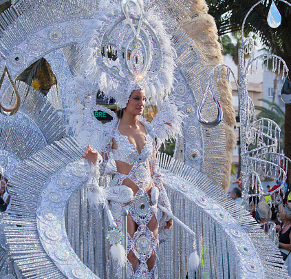 Las Palmas, Spain, February 16, 2013.  A beautiful woman in an elaborate costume rides a float in the Grand Carnival Parade.  Carnival and the parade are held annually on the Spanish Island of Gran Canaria in the Canary Islands.