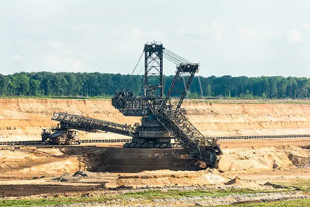 One of the world's largest bucket-wheel excavators is digging lignite (brown-coal) in of the world's deepest open-pit mines in Hambach in the Ruhr area in Germany.