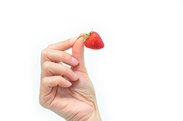 istock hands holding strawberry isolated on white 537518203