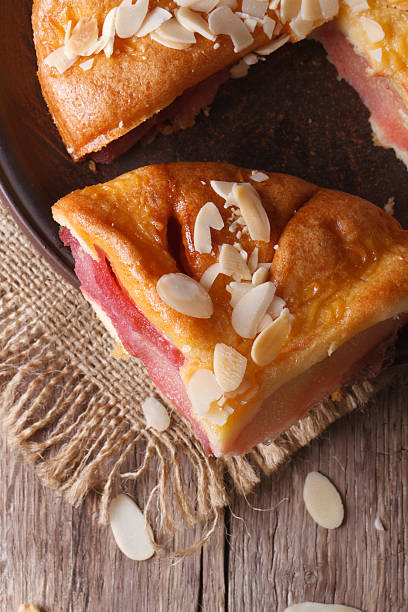 istock Piece of pear tart with almonds on plate closeup vertical 537518541