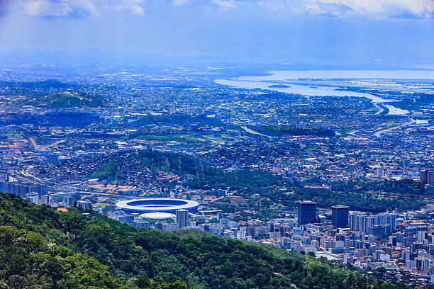 Rio de Janeiro, Brazil: Looking at City from Corcovado Looking at a section of the large South American City of Rio de Janeiro from the Corcovado peak. To the left of the image, the circular structure, is the well known Maracanã Stadium; and in front of it, the Maracanãzinho, or little Maracanã. In the far distance is the Atlantic Ocean.  Photo shot in the morning sunlight; horizontal format. Copy space. maracanã stadium stock pictures, royalty-free photos & images