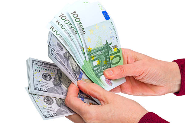 istock Hand with euro and dollar on white 537519595