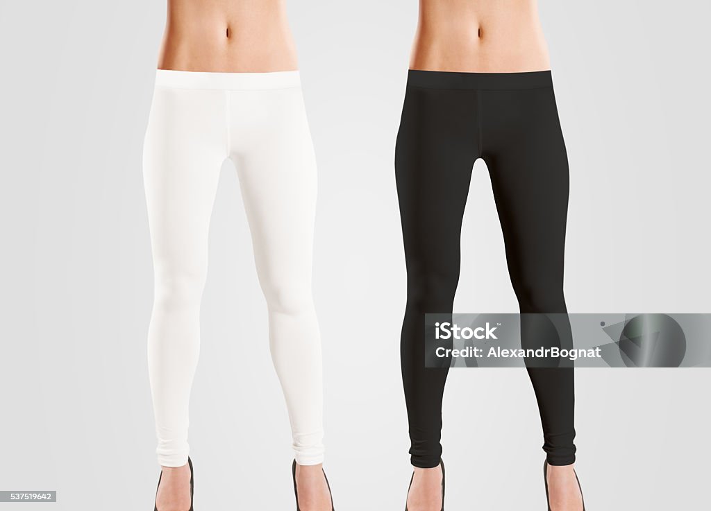 Woman wear blank leggings mockup, black, white, isolated on grey. Woman wear blank leggings mockup, black, white, isolated on grey. Women in clear leggins template. Cloth pants design presentation. Sport pantaloons stretch tights model wearing. Slim legs in apparel. Leggings Stock Photo