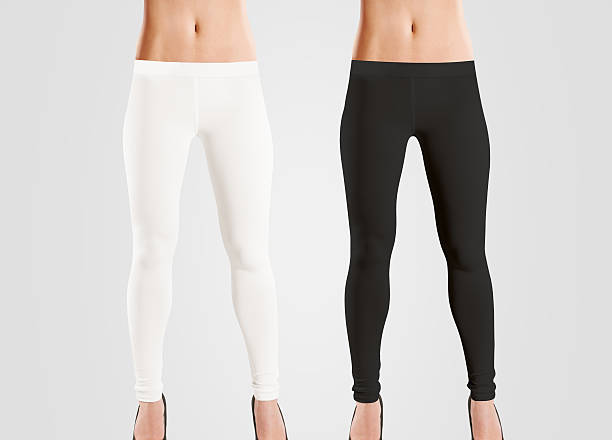 Woman wear blank leggings mockup, black, white, isolated on grey. Woman wear blank leggings mockup, black, white, isolated on grey. Women in clear leggins template. Cloth pants design presentation. Sport pantaloons stretch tights model wearing. Slim legs in apparel. leggings stock pictures, royalty-free photos & images