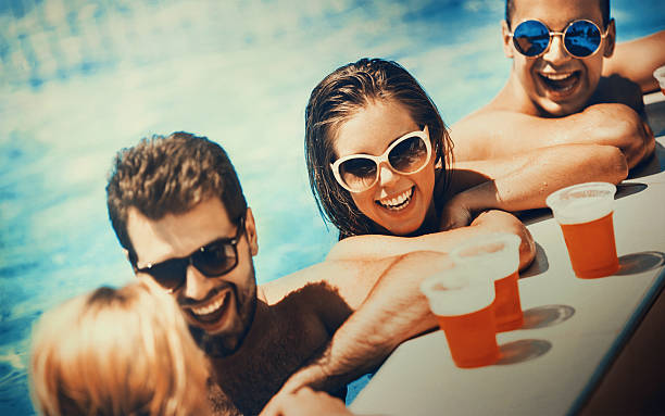 istock People enjoying drinks by the swimming pool. 537520124
