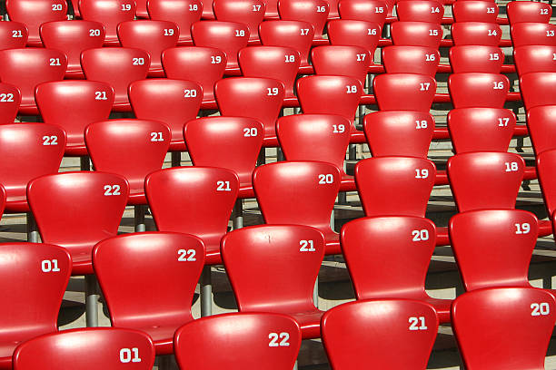 istock Red Tribune Seats in a stadium - side view 537524024