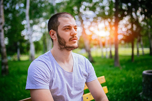 istock Guy sitting in the park on bench 537526970