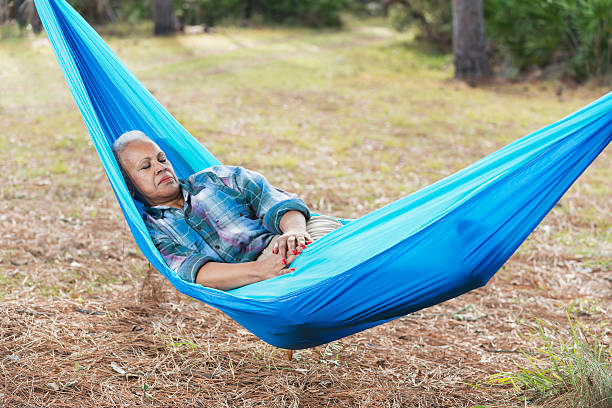 istock Senior African American woman sleeping in hammock 537527178