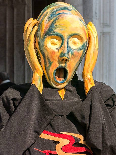 Model dresses as Munch's The Scream at the Venice carnival stock photo