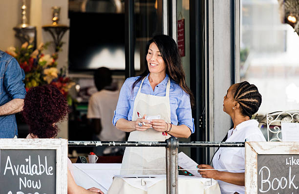 istock Coffee Shop Waitress Taking An Order From Customers 537534152