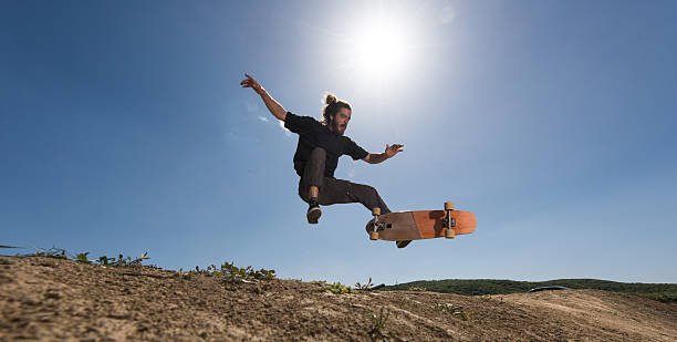 istock Young skateboarder practicing Ollie against the blue sky. 537535168
