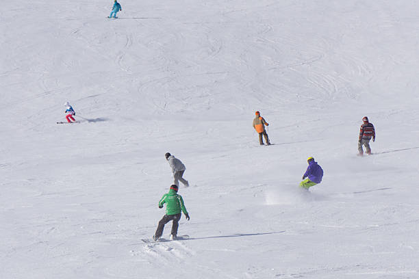 istock Skiers and snowboarders going down the slope. 537536083