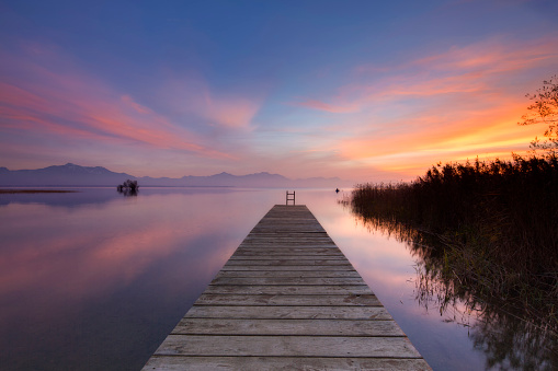 Lonely boat on silent water,  Lake Chiemsee at Sunset