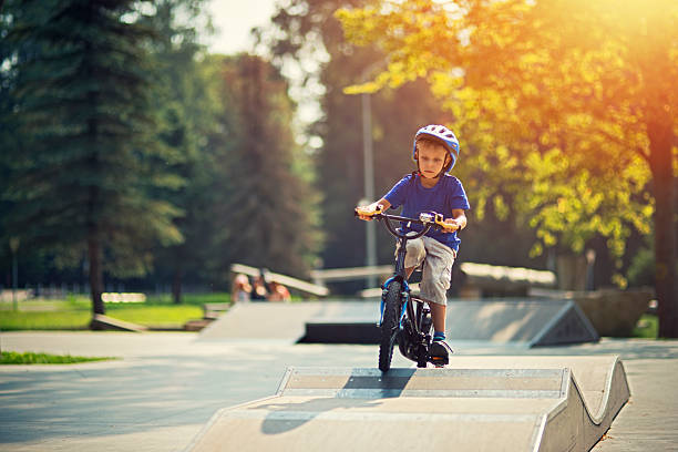 Little boy riding a bicycle on ramp