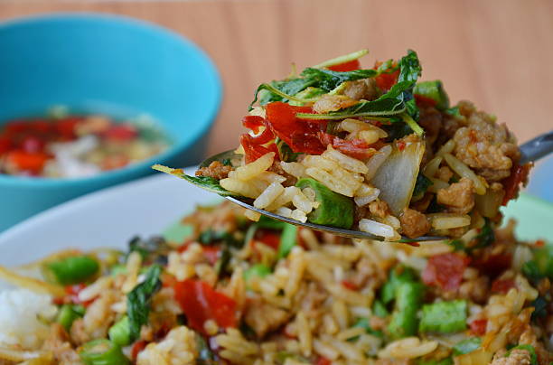 istock stir-fried spicy chop pork with basil leaf on spoon 537541180