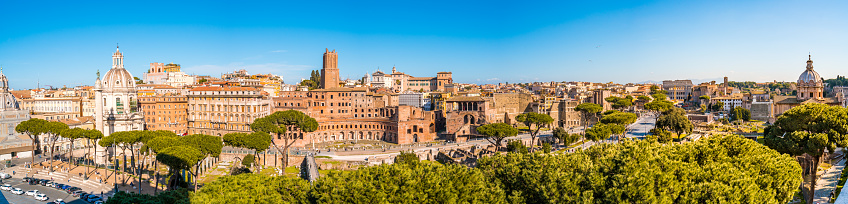 Panorama of the Roman Forum in Rome, Italy showing the Mercati di Traiano and city buildings