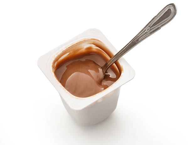 istock Open yogurt in pot with metal spoon 537545082