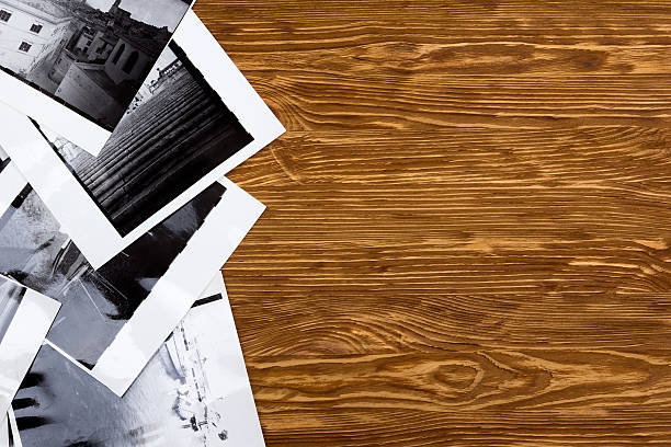 istock Black and white photos on wooden table background. 537545712