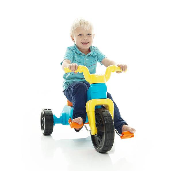 istock Smiling little boy riding tricycle 537546166