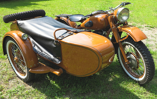 vintage motorcycle with sidecar parked on green grass