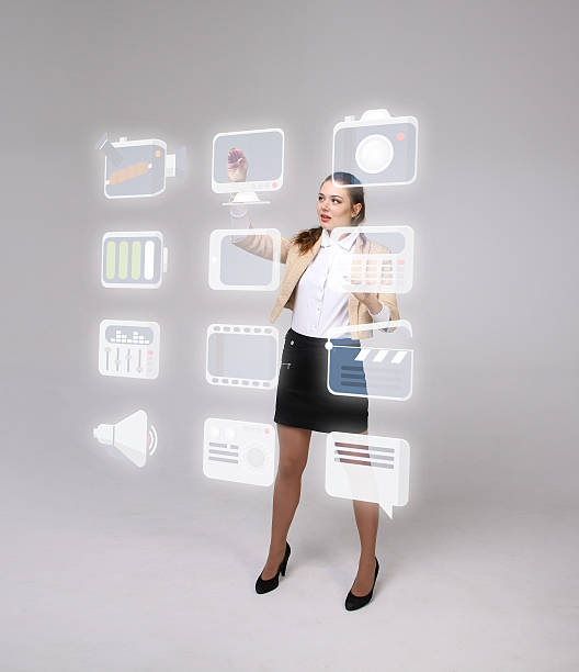 istock Woman pressing multimedia and entertainment icons on a virtual background 537547542