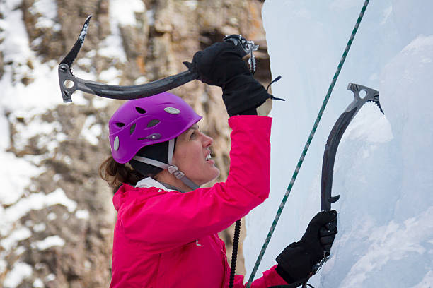 Woman ice climbing stock photo