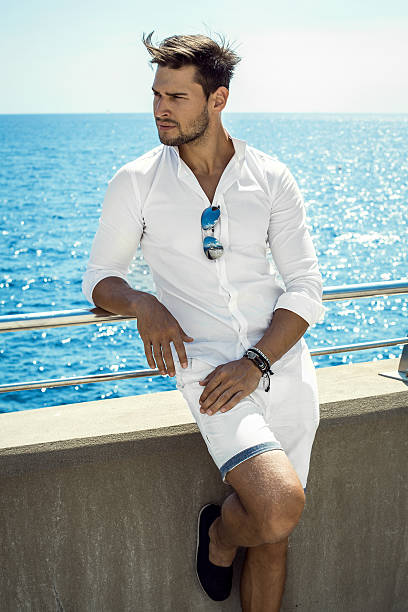 istock Handsome man in whit clothes resting by the sea 537549056
