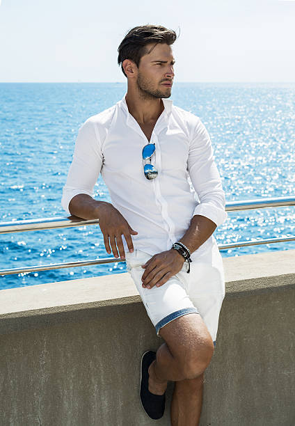 istock Good looking man wearing white clothes by the sea 537549316