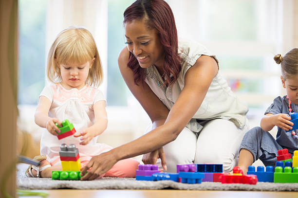 istock Teacher Playing with Preschoolers 537549632