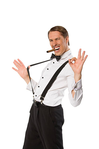 istock Man in suspenders smoke a cigar. 537550192