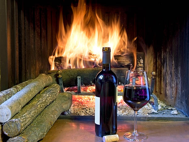 glass  wine in front of a fireplace stock photo