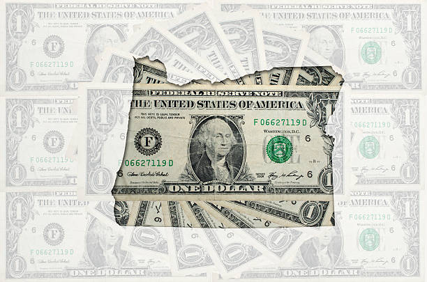 istock Outline map of oregon with transparent american dollar banknotes 537551245