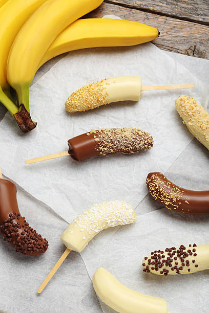 istock Banana covered in chocolate on a pergament 537551360